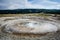 Bubbling and erupting geyser hot spring inside of Yellowstone National Park at the Biscuit Basin area