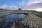 Bubbling mud. Mud volcano landscape at sunset - landmark attraction in Buzau, Romania