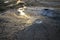 Bubbling mud. Mud volcano at sunset - landmark attraction in Buzau, Romania