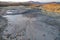 Bubbling mud. Mud volcano at sunset - landmark attraction in Buzau, Romania