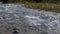Bubbling water in a boisterous river in a mountainous area.