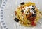 Bucatini pasta with peppers, capers, olives and cherry tomatoes