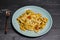 Bucatini pasta with tomatoes and veggies and vegan cheese