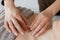 buccal facial and neck massage, close-up, cosmetologist makes woman a procedure on a massage table in a spa salon