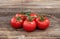 A buch of delicious tomatoes on wooden background