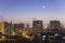 Bucharest neighbourhood cityscape at sunset under waxing crescent moon