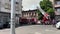 Bucharest, Romania - 05.07.2022: fire engine in a residential area with firefighters nearby extinguishing a burning abandoned buil