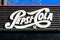 Bucharest, Romania, 1 January 2021 - Old vintage white logo of Pepsi Cola drink displayed on a dark background at a restaurant in