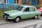 Bucharest, Romania, 19 March 2021 Old retro vivid green Romanian Dacia 1300 classic car parked in a street in a sunny spring day