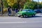 Bucharest, Romania, 24 October 2021: Old vivid green Romanian Dacia 1310 TX classic car produced in year 1987 in a street in the