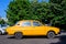 Bucharest, Romania - 5 June 2021: Old retro vivid yellow orange Romanian Dacia 1300 classic car parked in a street in a sunny