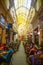 Bucharest, Rumania - 28.04.2018: People in Passage Macca Villacrosse, covered yellow glass passage in Bucharest