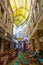 Bucharest, Rumania - 28.04.2018: People in Passage Macca Villacrosse, covered yellow glass passage in Bucharest