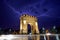 Bucharest Triumph Arch in the light storm by night