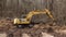 Bucket of backhoe digging soil at construction site. Crawler excavator digging. Excavating machine.