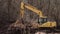 Bucket of backhoe digging soil at construction site. Crawler excavator digging. Excavating machine.