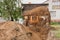 A bucket of a bulldozer fills the trench with earth in an industrial zone. Excavation construction works