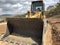 Bucket of crawler bulldozer. Earthmoving heavy machinery on the road construction works