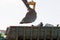 Bucket excavator against a blue sky with clouds