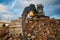 Bucket of excavator full of dismantled building leftovers