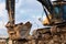 Bucket of excavator full of dismantled building leftovers