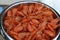 Bucket of fresh boiled pink small shrimps close up