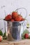 Bucket of freshly picked strawberries on a wooden table