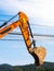 Bucket ground excavator with electrical messy wire cables.