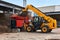 Bucket loader loads tree bark into an industrial woodchipper