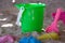 Bucket with moulds and spade on a beach