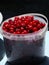 A bucket of red cherries. Transparent bucket with red cherries