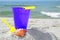 Bucket and seashell on beach