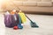 Bucket with sponges, chemicals bottles and mopping stick.