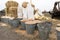 Buckets and bags of grain, bales of hay and straw. Village market of farmers. Barley, corn, wheat, rye, seeds, cake, millet, sorgh