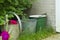 buckets and watering can standing in the garden to collect rainwater,