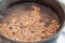 Buckwheat groats soaked before cooking in water in a cauldron