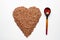 Buckwheat heart with a wooden spoon on a white background. Popular food in Russia
