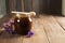 Buckwheat honey with flowers over wooden background