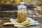Buckwheat kernels in a glass jar and a spoon on a wooden background, rustic authentic style. Copy space. Diet and food