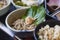 Buckwheat noodles with pate and with green shiso leaf.