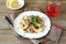 Buckwheat noodles with shrimp and cilantro on a white plate