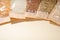 Buckwheat, peas, lentils, rice, oat flakes in paper - cellophane bags close-up. Beige backdrop, copy space