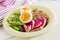 Buckwheat porridge buddha bowls with avocado, boiled eggs and watermelon radish