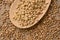 Buckwheat porridge. Wooden spoon. Cereal sprouts. Brown background