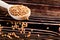 Buckwheat raw seeds in wooden spoon on wood table. Healthy eating background