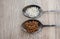 Buckwheat and rice in a spoon. Composition with different types of legumes and cereals on a wooden table. Organic grains.