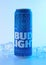 Bud Light american beer blue can chilled on a blue background with ice