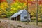 Bud Ogle log home surrounded with fall colored leaves.