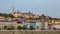 Buda castle over colorful buildings and Danube river embankment, Budapest