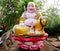 Budai sitting in lotos colorful statue